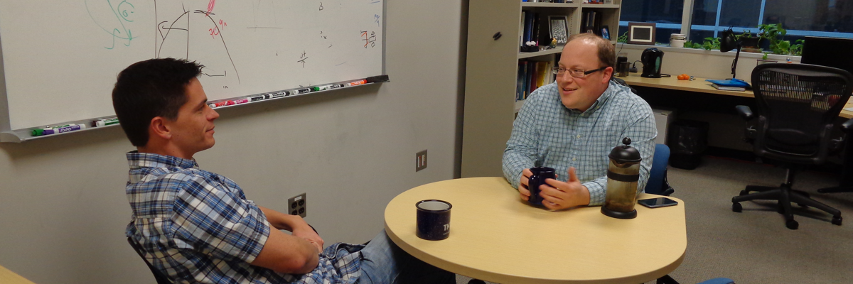 two people talking across a table